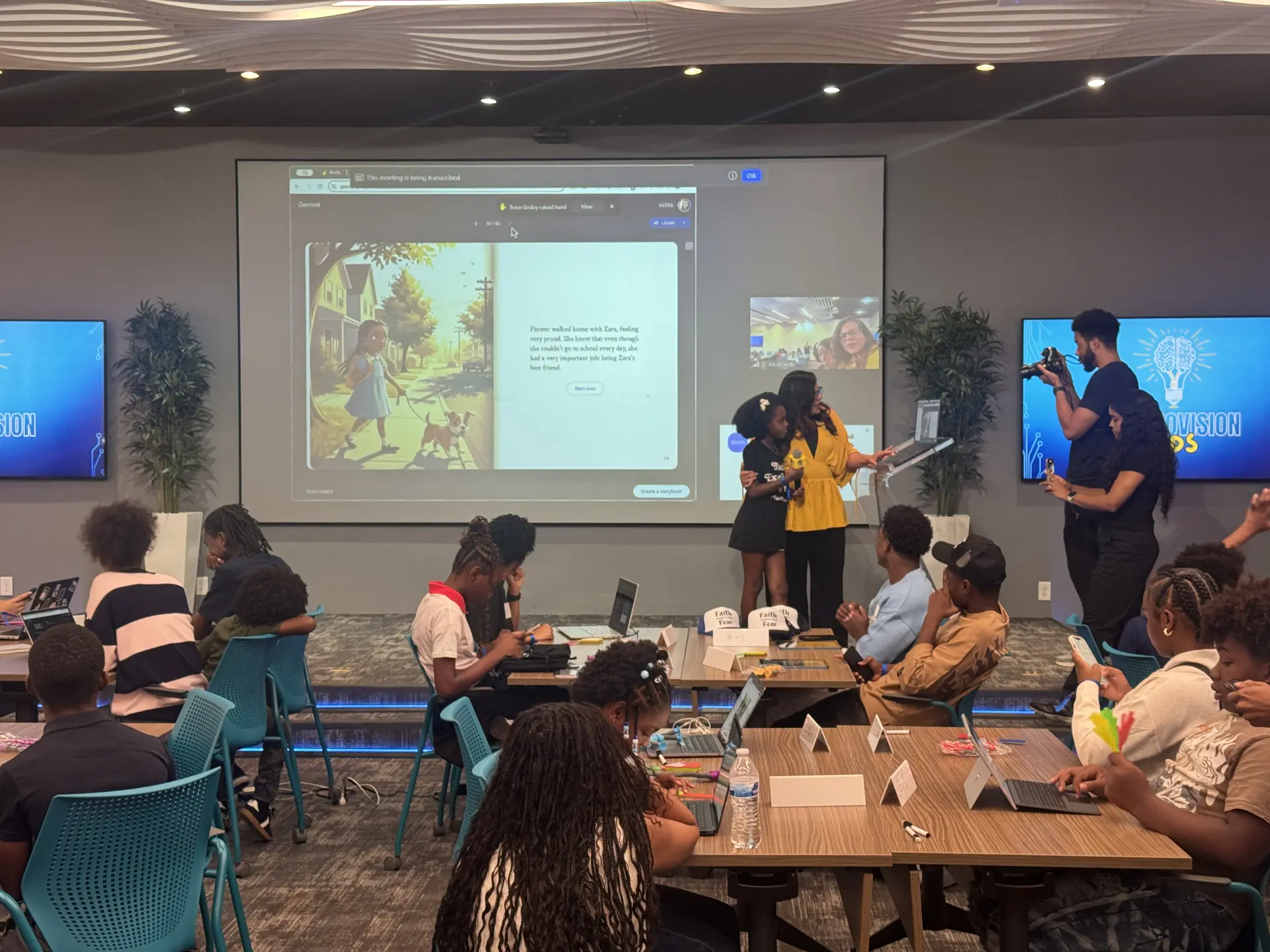 A child holding a microphone beside a facilitator while an illustrated storybook page is projected for the workshop audience
